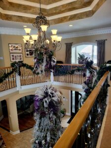 portfolio image of purple and white christmas decor in entry way of home