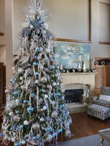 portfolio image of blue and silver christmas decor in a large living room,