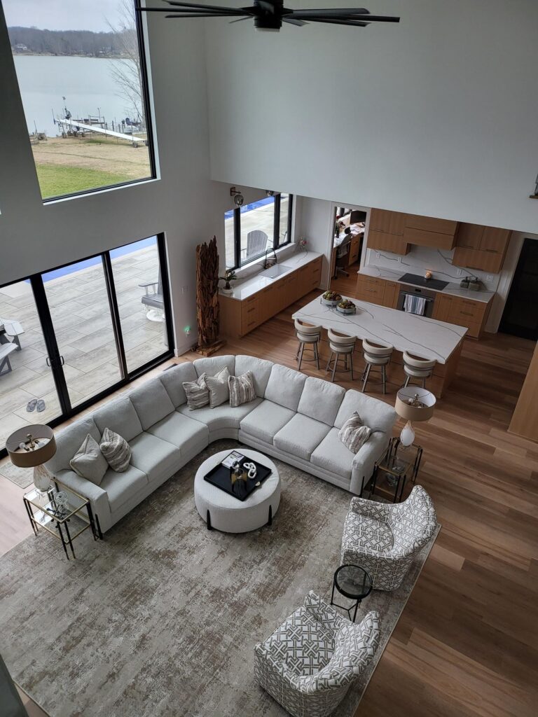 portfolio image of large living room with couch and view of kitchen, taken from above