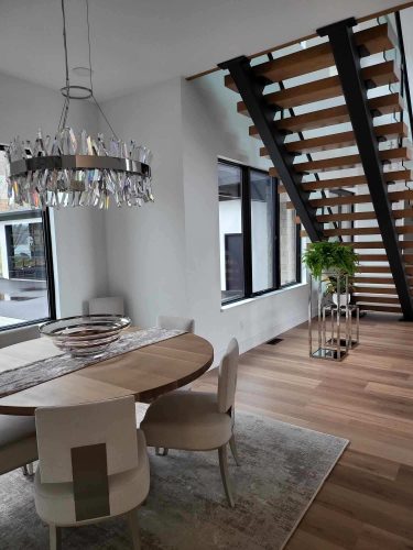 portfolio image of staircase and dining room in home