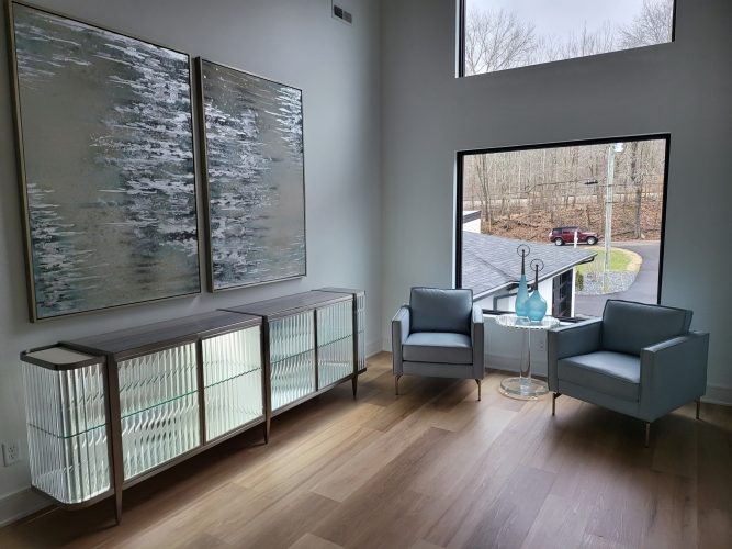 portfolio image of a sitting room with two chairs, wall art, and a large window
